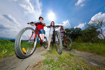 Fototapeta na wymiar Family riding bikes