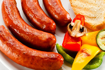 Grilled sausages, bread and  vegetables