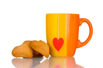 Orange cup with tea bag and heart-shaped cookies isolated