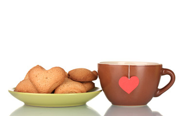 Brown cup with tea bag and heart-shaped cookies