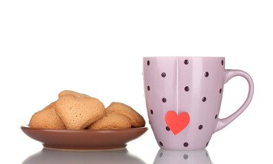 Pink cup with tea bag and heart-shaped cookies