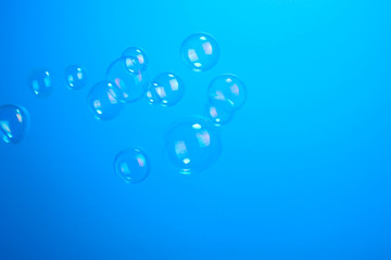 Soap bubbles on blue background