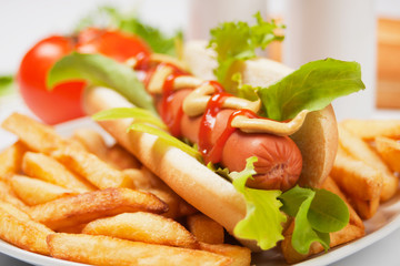 Hot dog with lettuce and french fries