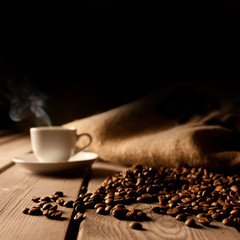 Coffee background with beans and white cup.