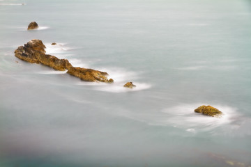 Rocks with crashing waves at Jurassic Coast, England, UK