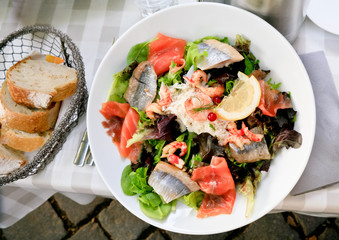 lunch  - plate of big salad with with salmon and herring