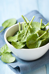 Fresh baby spinach in a small bowl