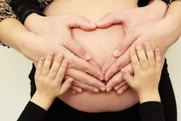 Heart from hands on pregnance bell
