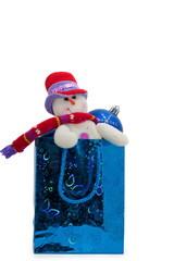 snowman and Christmas decorations in a gift bag