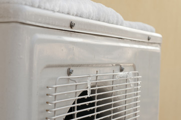 air conditioner covered by snow