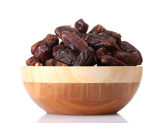 delicious dried dates in wooden bowl isolated on white