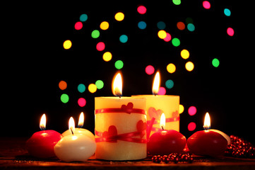 Beautiful candles on wooden table on bright background