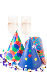 Fototapeta premium Party hats, confetti and glasses of champagne