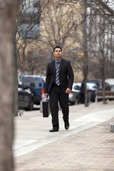 Hispanic Businessman - Walking Downtown With Briefcase