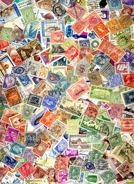 A pile of different postage stamps from around the world