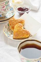 Romantic breakfast with tea, jam, butter and scones
