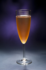 Champaign glass in front of blue purple background