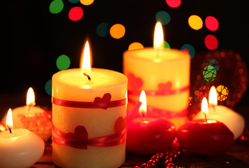 Obraz na płótnie Canvas Beautiful candles on wooden table on bright background