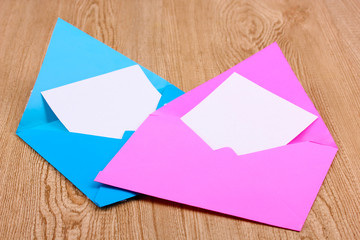 Color envelopes on wooden background
