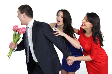 a man with a bouquet of flowers and two young women