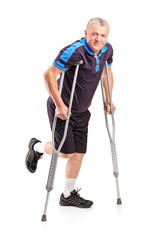 Full length portrait of an injured senior player on crutches