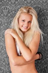 Fototapeta na wymiar Cute smiling blond girl in white bikini