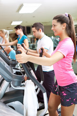 young healthy people exercising in gym