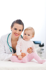 Portrait of pediatrician doctor with baby