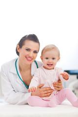 Portrait of happy pediatric doctor and baby