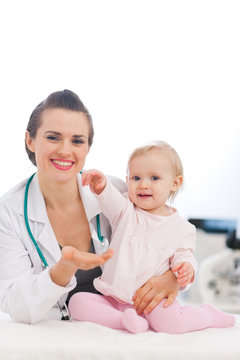 Lovely baby high five to pediatric doctor