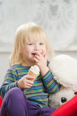 Adorable baby eat ice cream in kitchen