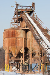 Fototapeta na wymiar Belt conveyors and silos in a gravel pit in winter