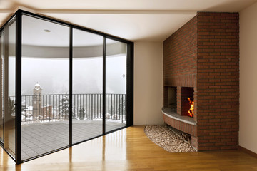 Interior with hardwood floors, large window and fireplace