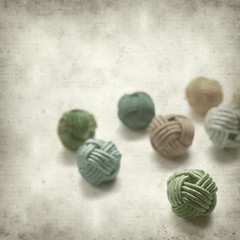 textured old paper background with beads in knotted style
