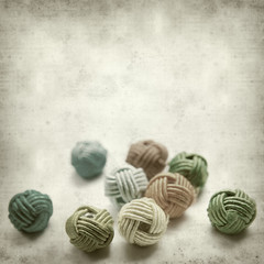 textured old paper background with beads in knotted style