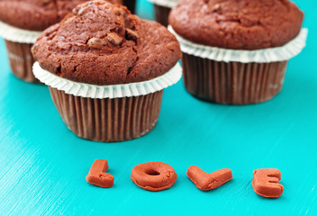 chocolate muffins on a blue wooden table