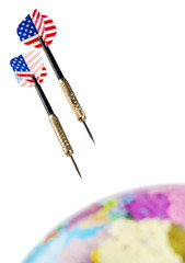 Darts with USA flag colors near globe
