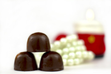 Sweets a beads and a candle.