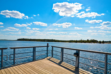 Fototapeta premium lake pier against the blue sky, angled view