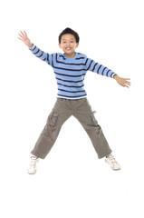 Happy little boy jumping in mid air isolated