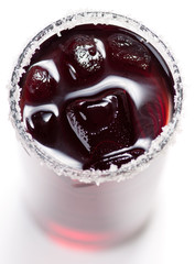 Red cocktail with ice on white