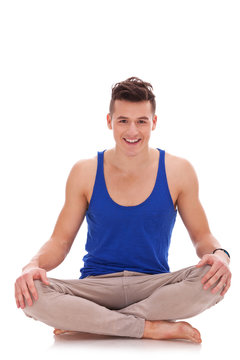 young barefoot man in a yoga position