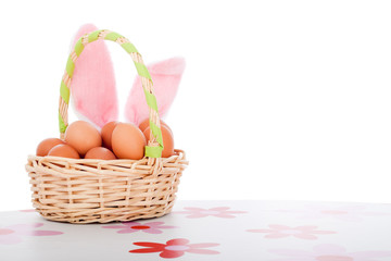 Fototapeta na wymiar Easter decoration basket with eggs and bunny ears