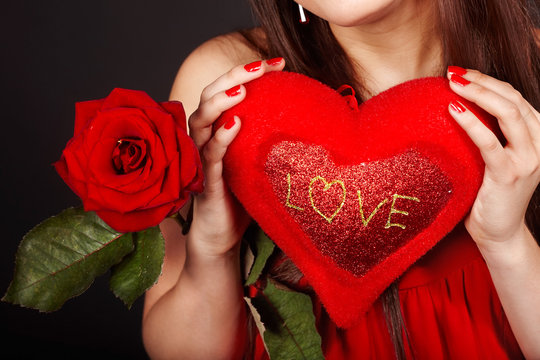 Girl with  heart and flower rose on red  background.