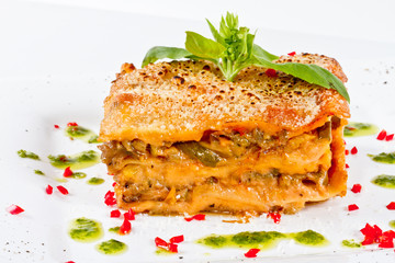 Closeup of lasagna and basil fork