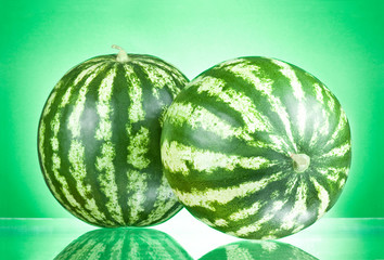 Two Watermelons isolated on a green background