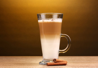 Fragrant сoffee latte in glass cup and cinnamon
