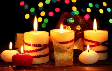 Beautiful candles on wooden table on bright background