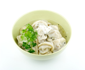 Meat pelmeni with sour cream and greens isolated