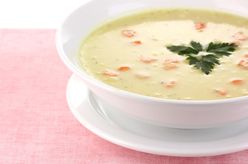 Tasty soup on pink tablecloth isolated on white